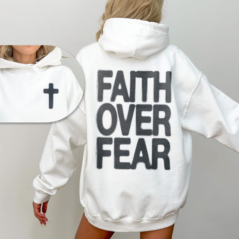 May include: White hoodie with a black cross on the front and the words "FAITH OVER FEAR" printed on the back.