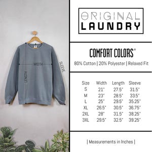 May include: A size chart for a sweatshirt with measurements in inches. The chart shows the size, width, length, and sleeve length for sizes S through 3XL. The sweatshirt is made of 80% cotton and 20% polyester and has a relaxed fit.