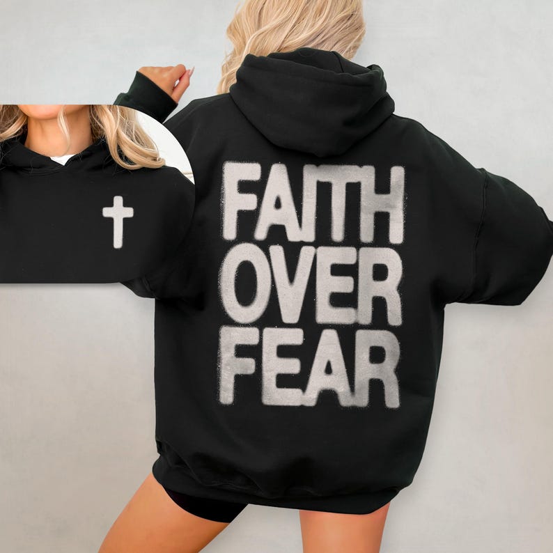 May include: Black hooded sweatshirt with the words "Faith Over Fear" printed in white on the back. A small white cross is visible on the left sleeve.