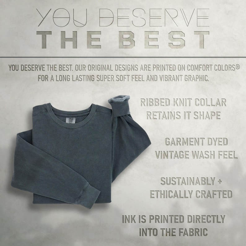 May include: A dark blue long-sleeved t-shirt with a ribbed knit collar. The shirt is garment dyed for a vintage wash feel. The text "YOU DESERVE THE BEST" is printed at the top of the image. The text "RIBBED KNIT COLLAR RETAINS IT SHAPE" is printed below the shirt. The text "GARMENT DYED VINTAGE WASH FEEL" is printed below the collar text. The text "SUSTAINABLY + ETHICALLY CRAFTED" is printed below the vintage wash feel text. The text "INK IS PRINTED DIRECTLY INTO THE FABRIC" is printed at the bottom of the image.