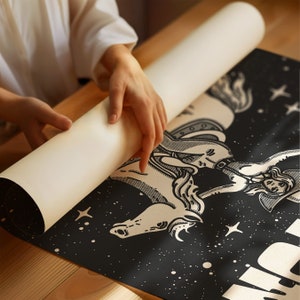 May include: A black and white illustration of a woman riding a horse with stars in the background. The woman is wearing a hat and a long dress. The horse is rearing up on its hind legs. The illustration is printed on a black canvas.