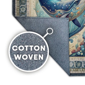 May include: A cotton woven rug with a detailed illustration of a whale in shades of blue, teal, and gold. The rug features floral and ornamental patterns, with the text "COTTON WOVEN" in a circular inset.