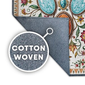 May include: A rectangular rug featuring a floral pattern with turquoise and orange oval gemstone motifs. A circular inset highlights the gray, textured underside of the rug with the text COTTON WOVEN clearly printed in white capital letters.