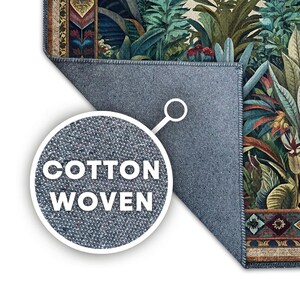 May include: A cotton woven rug with a botanical design featuring lush green and teal foliage, accented with red flowers and a patterned border. The rug's backing is a solid blue-gray color. The words "COTTON WOVEN" are displayed in a white circle.