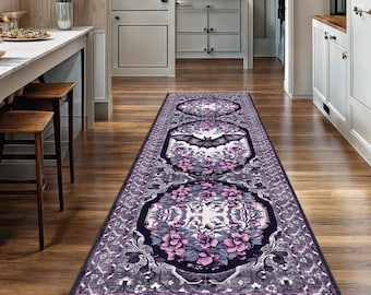 May include: A long, rectangular rug with a floral and bat design. The rug features a repeating pattern of purple and gray floral medallions and a central bat motif. The rug is placed on a hardwood floor.