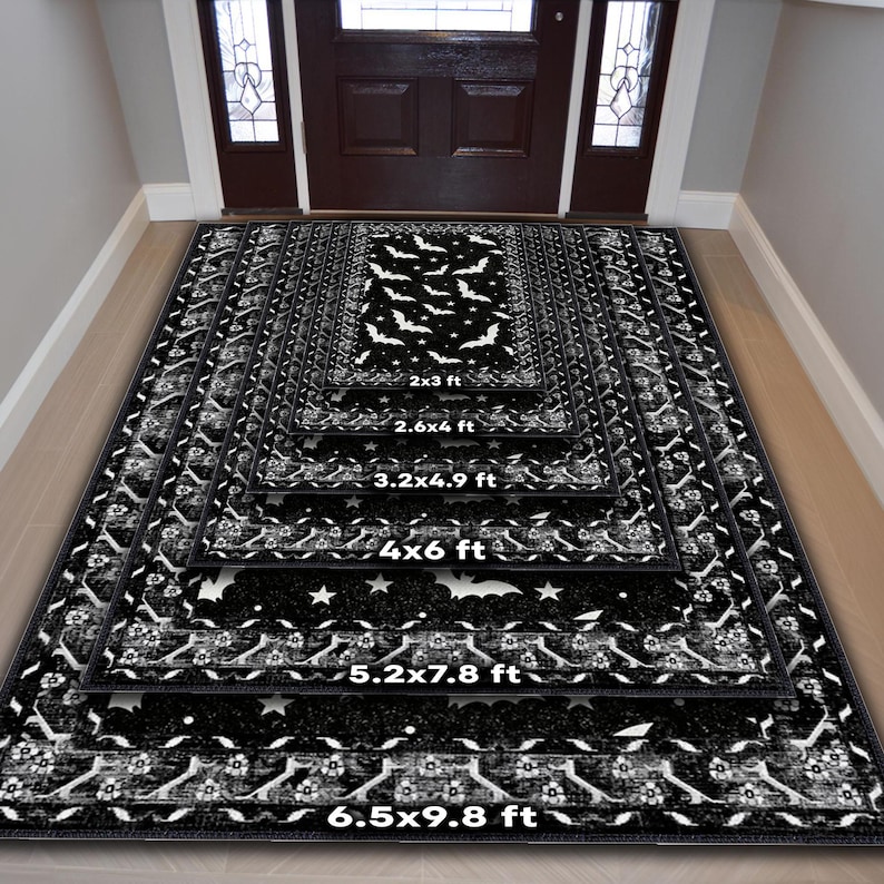 May include: Black and white Halloween-themed rugs in various sizes, featuring bat and star patterns. Sizes range from 2x3 ft to 6.5x9.8 ft. The rugs have a decorative border and are displayed in a hallway setting.