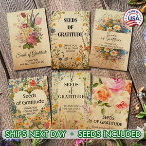 May include: A collection of seed packets with floral designs and the text "Seeds of Gratitude." Each packet features a different flower arrangement and the message "Thank you for all that you do." The packets are arranged on a wooden surface.