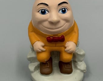 Humpty Dumpty Plastic Figurine Egg Shaped Face Man Sitting On Wall 2.5”