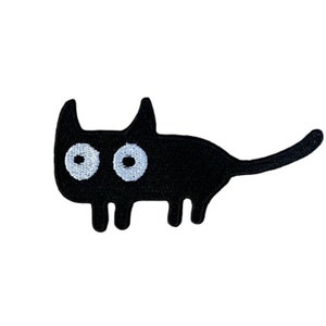 May include: Black embroidered iron-on patch of a cartoon cat with large white eyes.