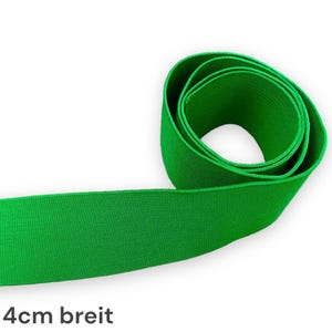 Może przedstawiać: Rolka jasnozielonej gumki, o szerokości 4 cm. Gumka jest złożona i zwinięta, co pokazuje szerokość taśmy.