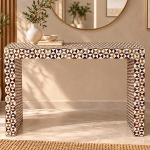 May include: A rectangular console table featuring a geometric pattern of alternating brown and white triangular inlays. The table has a flat top surface and two vertical side panels, creating a clean, structured silhouette with a repeating mosaic design.