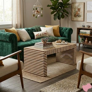 May include: A living room scene featuring a dark green tufted sofa with various throw pillows in cream and yellow. A striped coffee table sits on a neutral rug. Decorative items include a fox print and a hanging mobile.