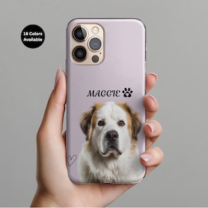 May include: A lilac phone case with a Saint Bernard dog portrait. The case is personalised with the name "Maggie" and a paw print. A small heart is drawn on the case. The text "16 Colors Available" is in a black circle.