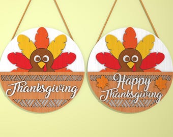 May include: Two round wooden Thanksgiving signs with a turkey design. One sign says "Thanksgiving" and the other says "Happy Thanksgiving".