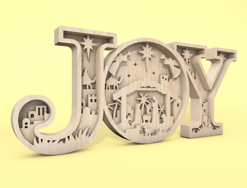 May include: Wooden cutout of the word "JOY" with a nativity scene inside the letter "O".