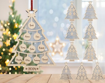 May include: A wooden Christmas tree ornament with a clear acrylic insert for adding names. The ornament is decorated with snowflakes and the year 2024. The ornament is hanging from a red ribbon.