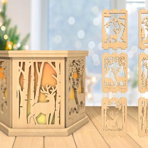 May include: A wooden lantern with a hexagonal base and intricate cutouts of trees and deer. The lantern is illuminated from within, casting a warm glow. The lantern is surrounded by smaller wooden panels with similar cutouts, depicting various scenes of deer in a forest setting.
