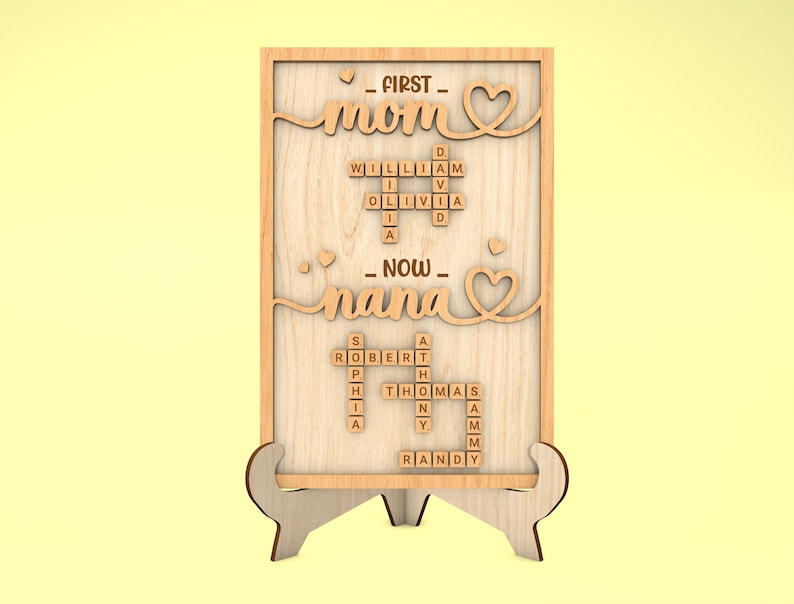 May include: Wooden sign with the words "FIRST - mom" and "NOW - nana" spelled out with Scrabble tiles. The tiles are arranged in a crossword puzzle pattern.