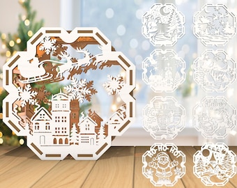 May include: A wooden Christmas decoration with a layered design depicting a winter village, snowflakes, and Santa's sleigh. Additional cut-out designs include various winter scenes and a Santa Claus figure. The decoration is set on a wooden surface.