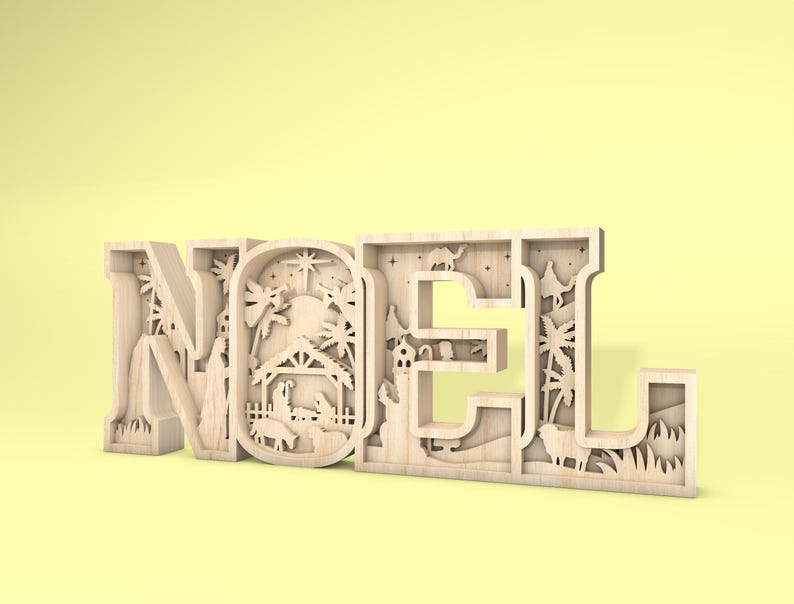 May include: A wooden cutout of the word "NOEL" with a nativity scene design inside each letter. The letters are painted in a light brown color and the background is a light yellow.