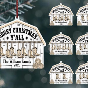 May include: Wooden Christmas ornament shaped like a barn, with the text "Merry Christmas Y'all" and "The William Family 2025". The ornament features hanging cowboy boots and snowflake details.