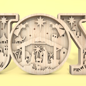 May include: Wooden JOY sign with a detailed nativity scene cutout in the centre of the O. The scene includes a manger, a star, palm trees, and figures of Mary, Joseph, and baby Jesus.