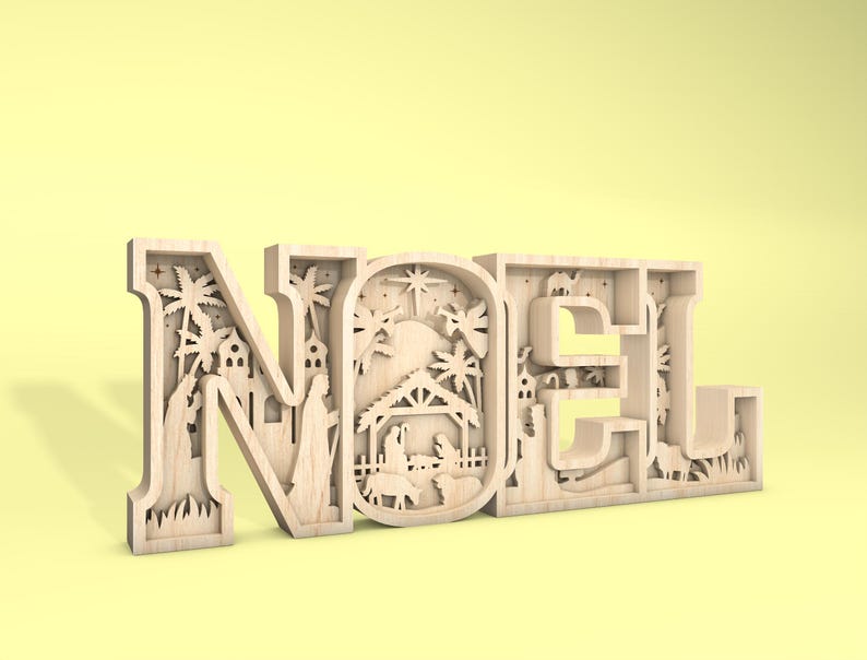 May include: A wooden cutout of the word "NOEL" with a detailed nativity scene design inside each letter. The cutout is painted in a light wood color and has a rustic, vintage feel.