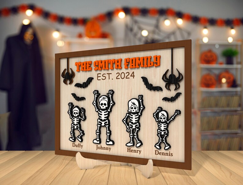 May include: A wooden sign with a Halloween theme featuring a family of skeletons. The sign reads "The Smith Family Est. 2024" and features the names "Duffy, Johnny, Henry, and Dennis".