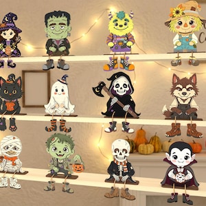 Può includere: Una collezione di dodici figure piatte in legno da scaffale raffiguranti personaggi di Halloween, tra cui una strega, il mostro di Frankenstein, un mostro, uno spaventapasseri, un gatto nero, un fantasma, il tristo mietitore, un lupo mannaro, una mummia, uno zombie, uno scheletro e un vampiro.