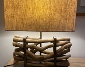 Cokwe wooden-effect fluted lamp with white shade.