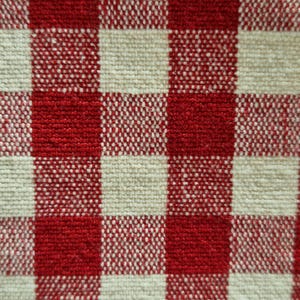 close up photo of a beautiful gingham red checked fabric for a cotton clothes page bag.