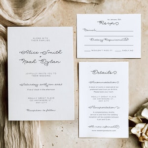 May include: Elegant wedding invitation suite with three white cards. The main card features the names "Alice Smith + Noah Dylan" and wedding details. The RSVP card and details card are also included. The suite is set against a neutral background.