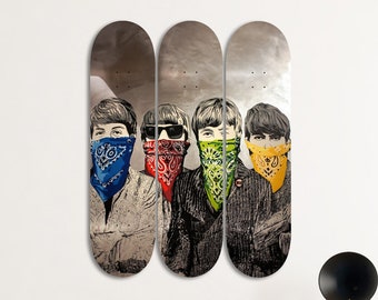 May include: Three skateboard decks with a graphic of four men wearing bandanas. The bandanas are blue, red, green, and yellow. The men are looking at the camera.