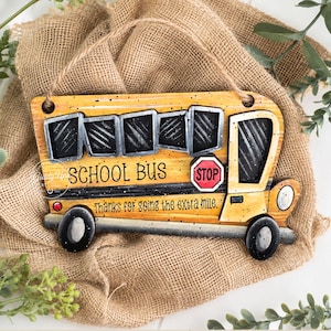 May include: A yellow wooden school bus sign featuring black windows, a red stop sign, and the text SCHOOL BUS and Thanks for going the extra mile. The sign includes two holes at the top for hanging and is designed as a digital download file.