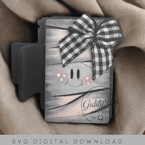 May include: A gray wooden block with a smiling face, pink cheeks, and a black and white checkered bow. The block has a dark gray attachment. The text on the image reads: SVG DIGITAL DOWNLOAD. NO PHYSICAL ITEM WILL BE SENT.