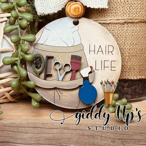 Accessorize in style with this trendy Hair Stylist Christmas Ornament SVG File! Perfect for DIY crafters and jewelry makers, this digital download allows you to create custom earrings showcasing your love for hair styling. Giddyupsstudio