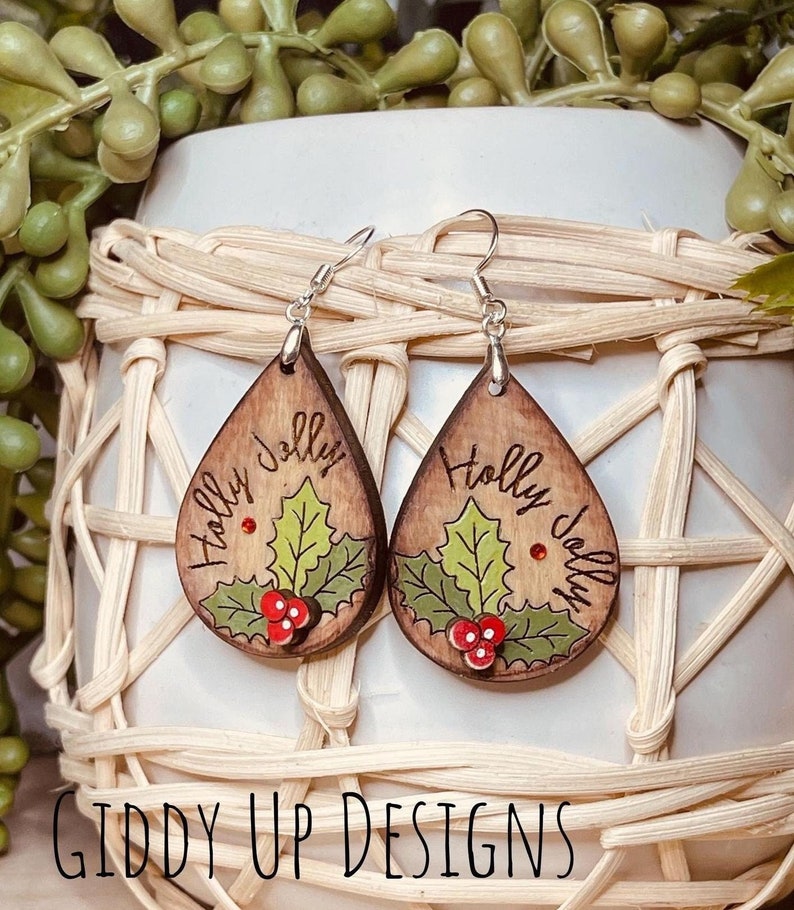 Get into the festive spirit with these Holly Jolly Christmas Earrings SVG! Perfect for those who love to add a touch of holiday cheer to their accessories. These downloadable file allow you to create your own unique earrings with a holly jolly flair.