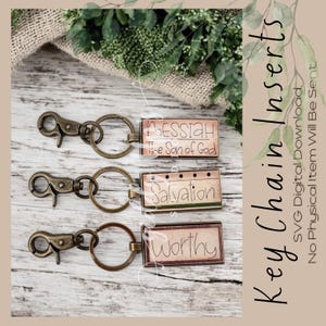 May include: Three keychains with different designs. The top keychain has a light pink rectangle with the text "Messiah The Son of God". The middle keychain has a light green rectangle with the text "Salvation". The bottom keychain has a light brown rectangle with the text "Worthy".