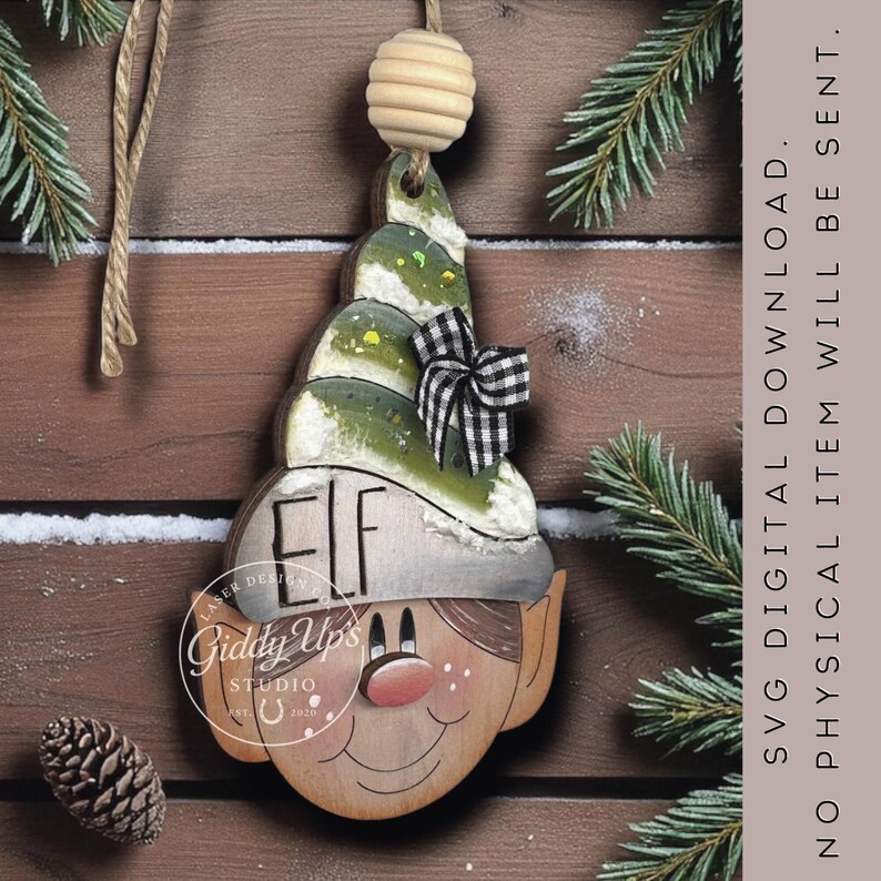 May include: Wooden elf-shaped Christmas ornament with a green and white hat, a black and white checkered bow, and the word "ELF" on the hat. The ornament has a smiling face and is hanging from a wooden bead.