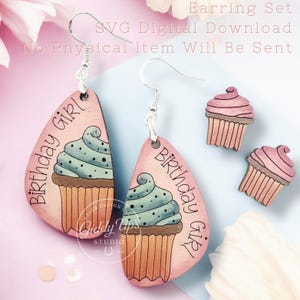 May include: A set of earrings and two matching stud earrings. The earrings feature a pink teardrop shape with a cupcake design and the words "Birthday Girl". The cupcake has blue frosting and a brown base. The text "SVG Digital Download" is also visible.