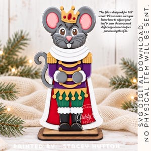 May include: A wooden mouse nutcracker figure wearing a gold crown with a red gem, a purple jacket with gold trim, green pants, and a red cape. The text reads: This file is designed for 1/8" wood. SVG DIGITAL DOWNLOAD. NO PHYSICAL ITEM WILL BE SENT.