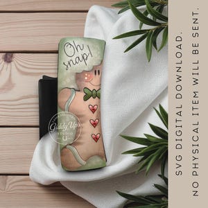 May include: A tumbler wrap featuring a gingerbread man design with the text "Oh snap!". The gingerbread man has a green bow tie and red heart accents. The design includes the text "SVG DIGITAL DOWNLOAD. NO PHYSICAL ITEM WILL BE SENT."