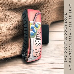 May include: A decorative hair clip featuring a margarita design with the text "GET SALTY." The clip has a black base and a colorful illustration of a cocktail with ice cubes and a straw. The clip is a digital download.