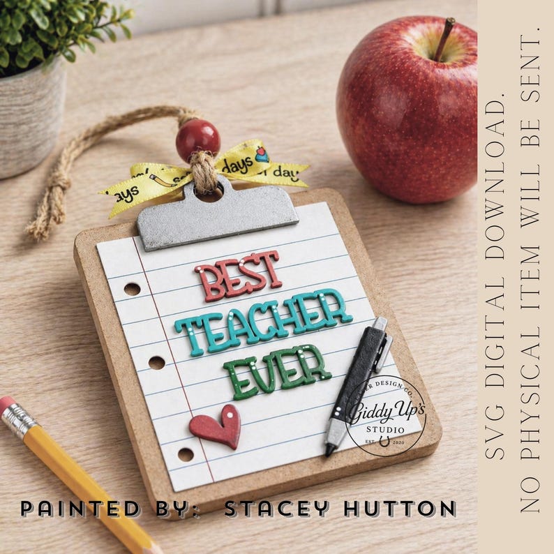 May include: A wooden clipboard with lined paper and the words "BEST TEACHER EVER" in colorful letters. A red heart and a pen are also on the paper. A red apple, a pencil, and a small plant are also in the image.
