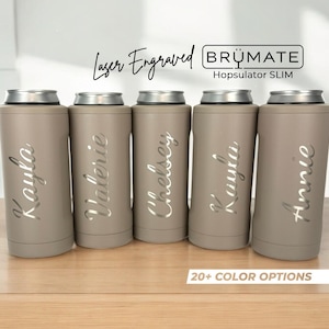 May include: Five matte taupe Brümate Hopsulator Slim can coolers with silver metallic rims. Each cooler features a unique laser-engraved name in a cursive script font. The text Laser Engraved BRÜMATE Hopsulator SLIM and 20+ COLOR OPTIONS is visible.