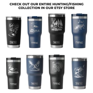 a collection of eight stainless steel tumblers with various hunting and fishing motifs engraved on them.