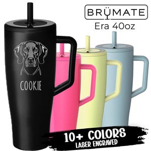 May include: A black 40oz Era tumbler with a dog portrait and the name "COOKIE" laser engraved. Other tumblers in pink, yellow, and blue are also shown. The image includes the text "10+ COLORS LASER ENGRAVED".