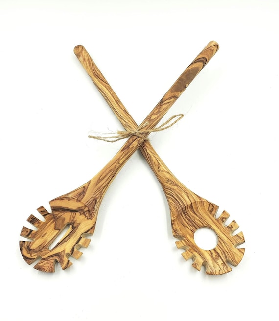 Hand-carved olive wood pasta scoop from Italy — the grain patterns mean every single one looks different, and it smells faintly of olive wood forever.