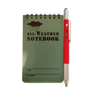 May include: A green all-weather notebook with a rain cloud graphic and the text "ALL-WEATHER NOTEBOOK". The notebook has a spiral binding and a space for a name and ID number. A red and silver multi-tool pen is next to the notebook.