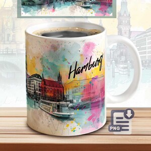 May include: White ceramic coffee mug with a watercolor design of the Hamburg skyline. The design features colorful buildings, water, and the word "Hamburg" in a stylized font.